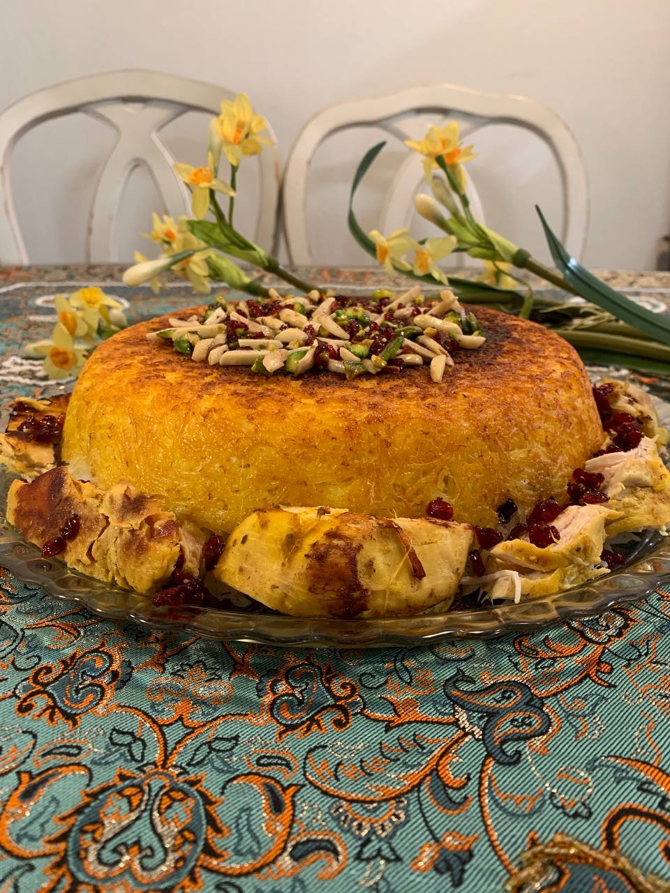 A slice of Saffron Pistachio Cake with a delicate cream frosting.